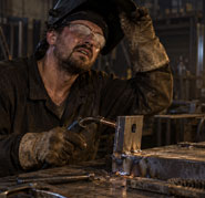 A welder struggling with a fogged visor and trapped heat